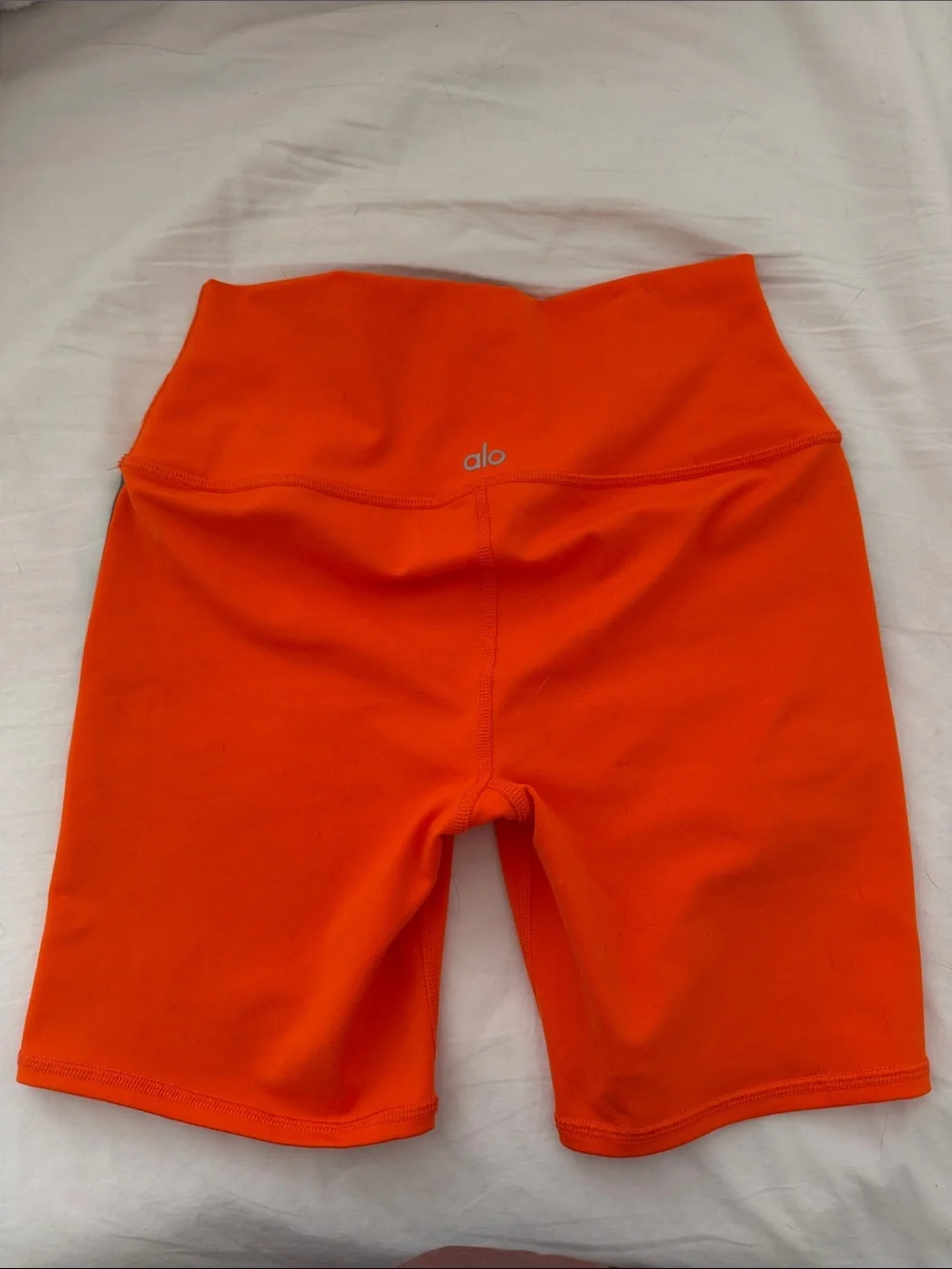 ALO Yoga Orange High-Rise Bike Shorts with Dark Stripe Detail